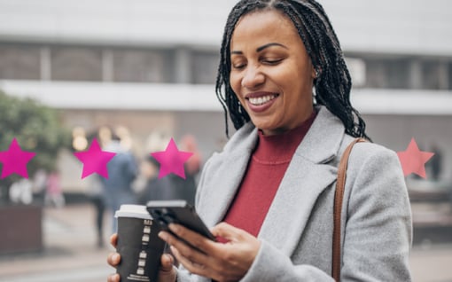 Photo of smiling woman outdoors using her phone to connect with a company